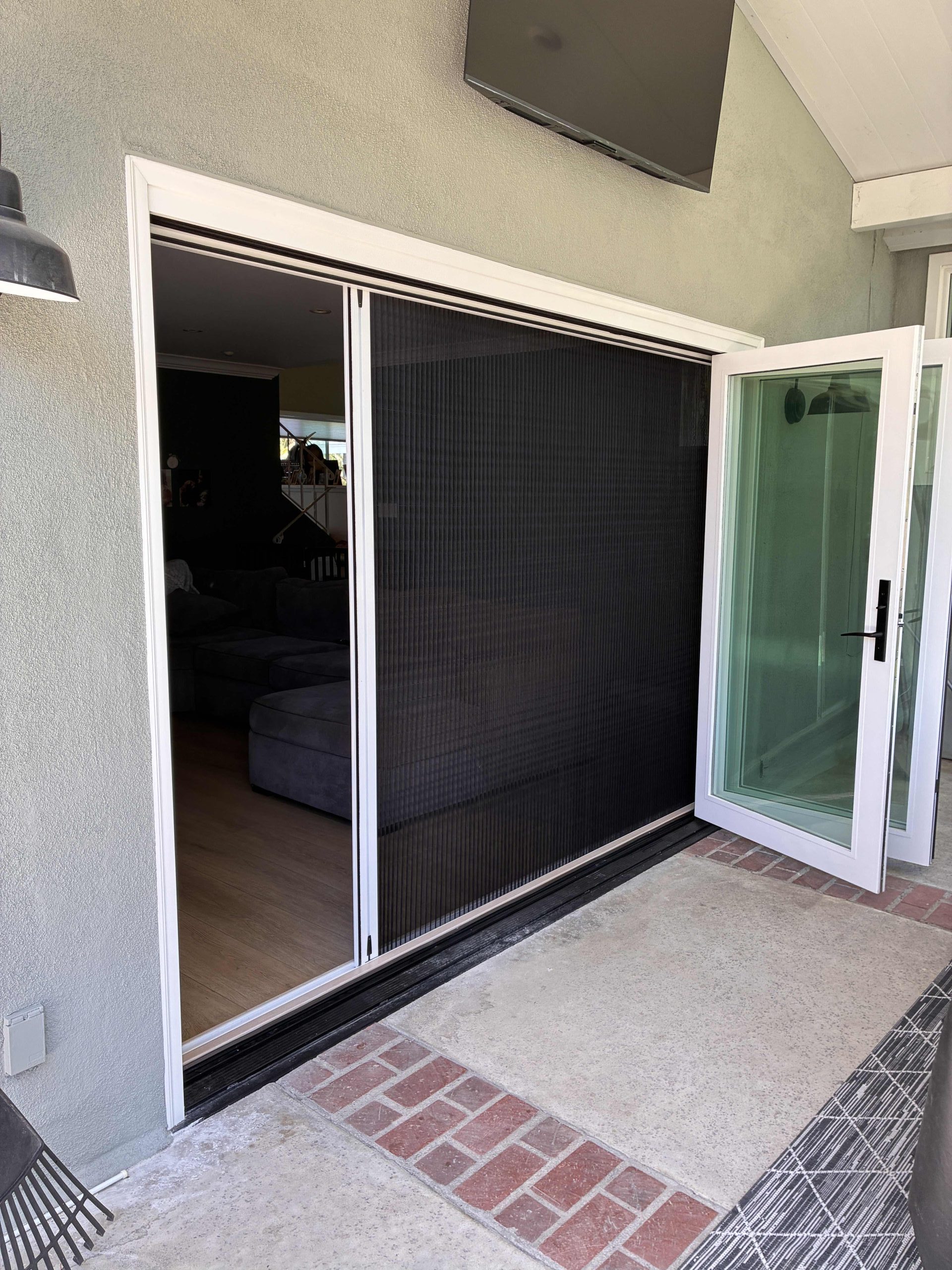 Bi-fold door to the patio with a retractable screen that is open half way